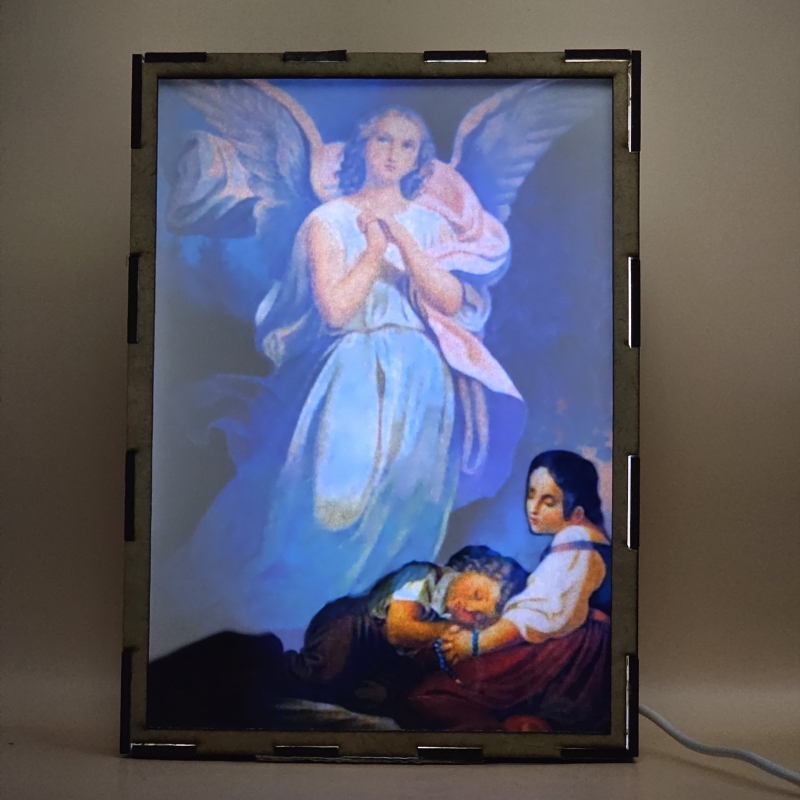 Lámpara con doble imagen  (Ángel de la guarda), vista encendida, con luz ambiente, donde se revela la ilustración completa al encender la luz LED.