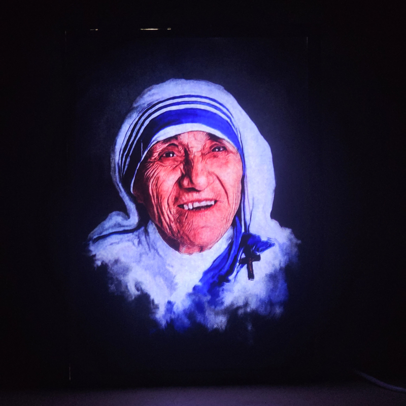 Lámpara con doble imagen  (Santa Teresa de Calcuta), vista encendida, donde se revela la ilustración completa al encender la luz LED.