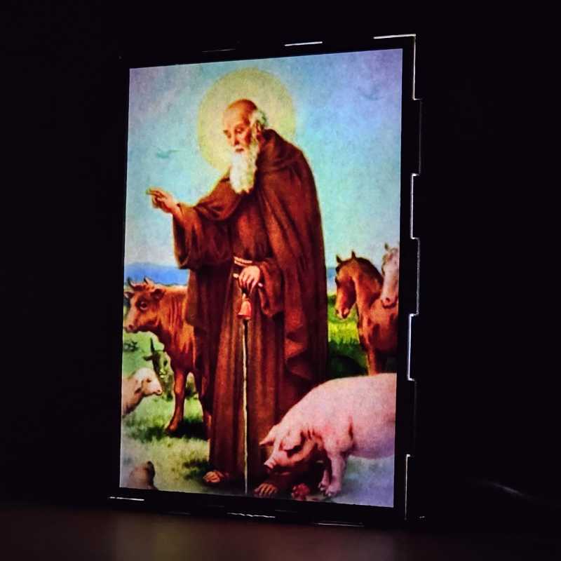 Lámpara con doble imagen  (San Antonio Abad), vista encendida, donde se revela la ilustración completa al encender la luz LED.