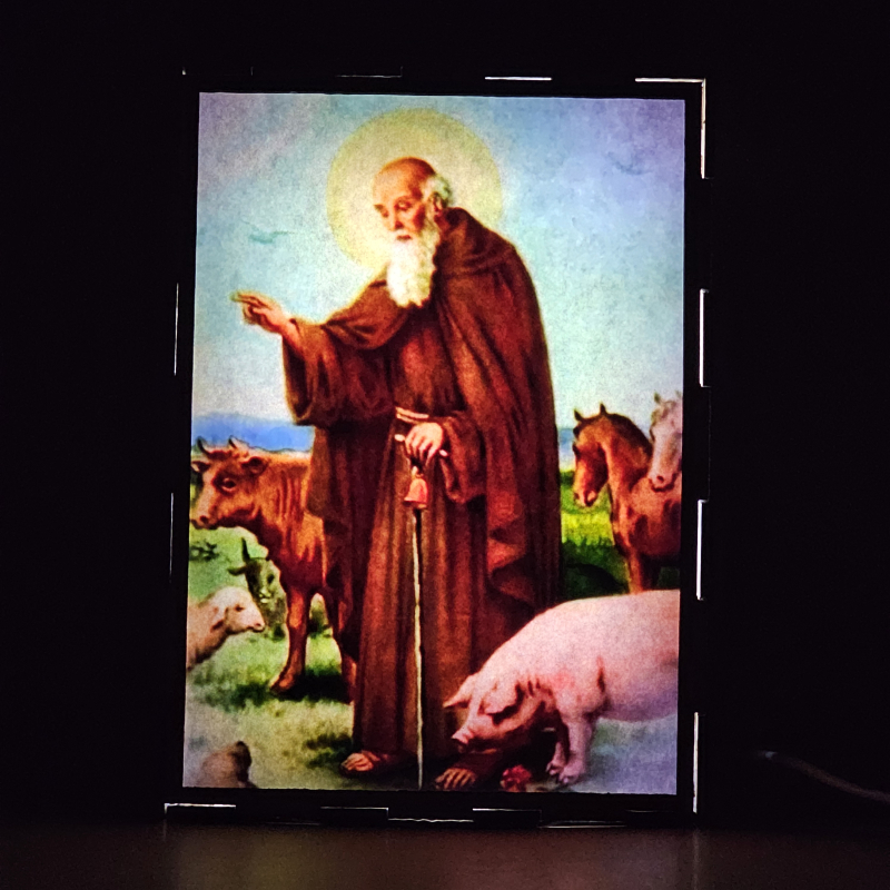 Lámpara con doble imagen  (San Antonio Abad), vista encendida, donde se revela la ilustración completa al encender la luz LED.