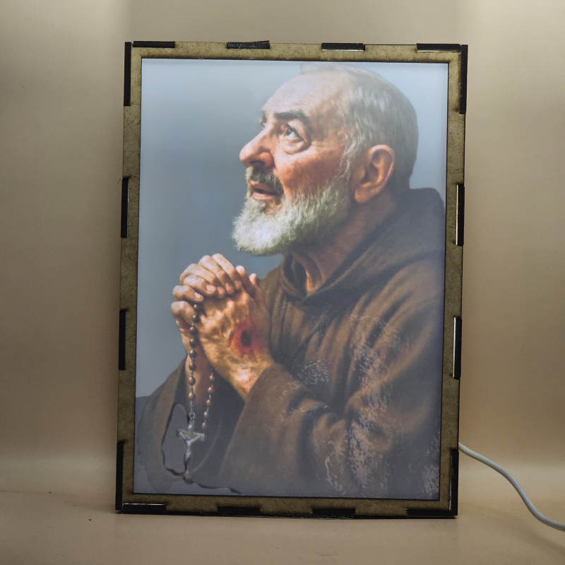 Lámpara con doble imagen  (San Pío de Pietrelcina), vista encendida, con luz ambiente, donde se revela la ilustración completa al encender la luz LED.