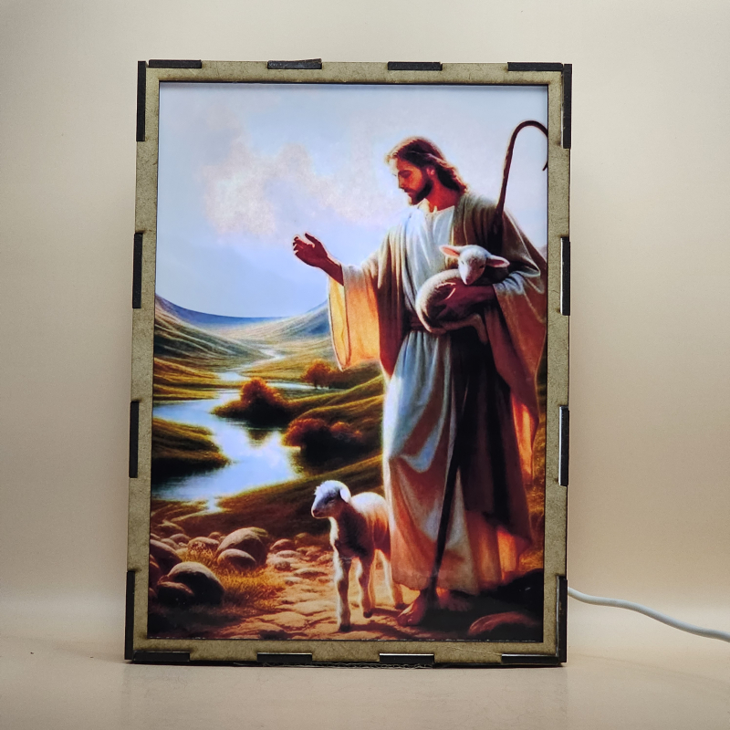 Lámpara con doble imagen  (Jesucristo buen pastor), vista encendida, con luz ambiente, donde se revela la ilustración completa al encender la luz LED.