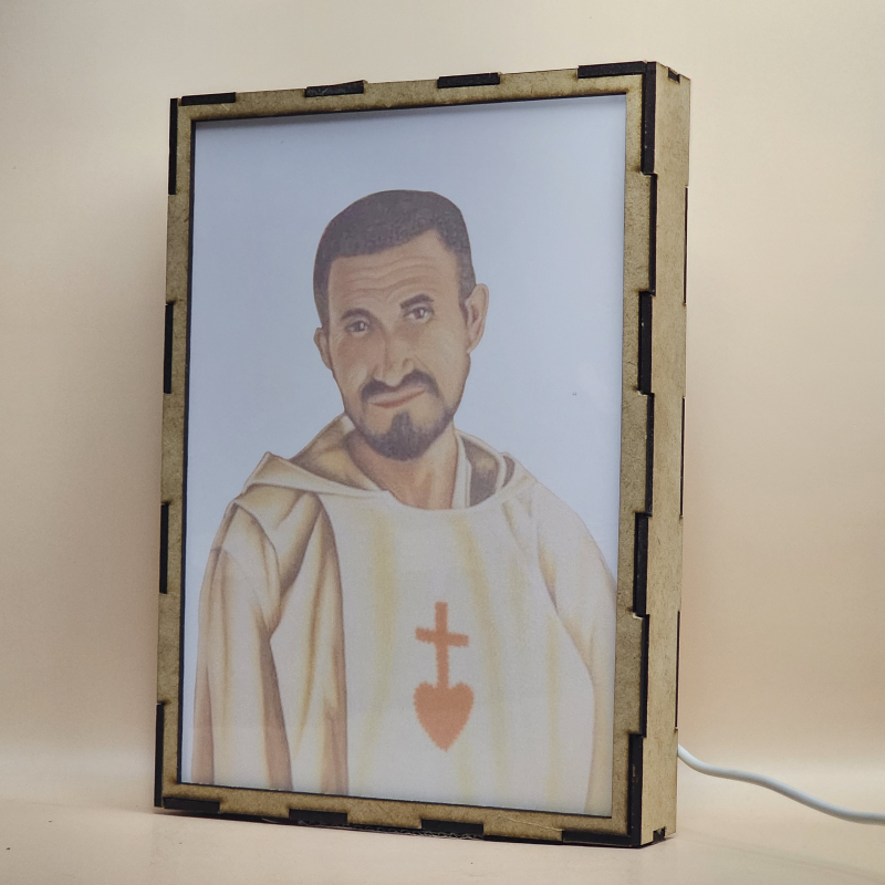 Lámpara con doble imagen  (Carlos de Foucauld), vista apagada, se esconde la imágen de atras.